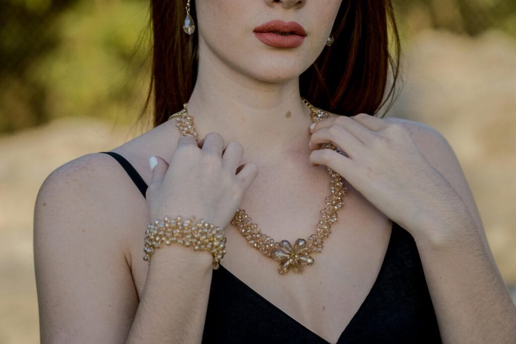 Stylish portrait featuring woman with pearl jewelry including necklace and earrings.